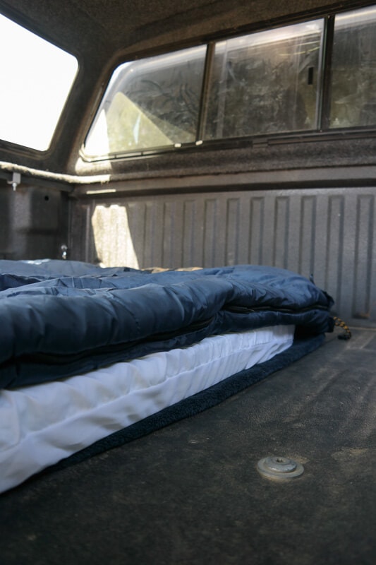truck bed camping with a mattress topper