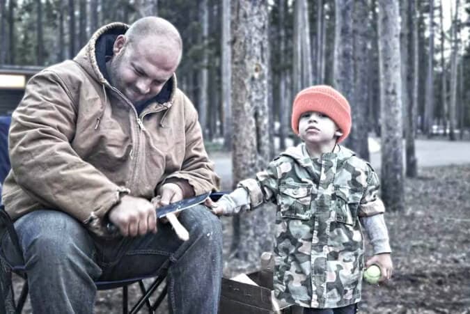 father backwoods camping with toddler