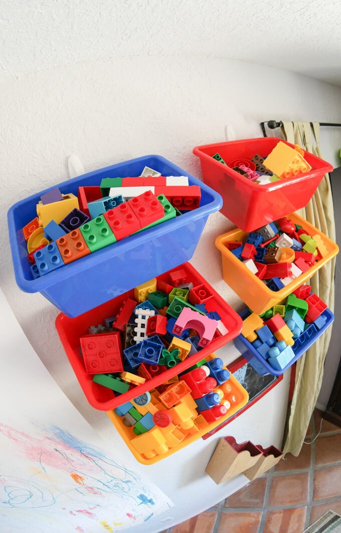 Lego storage - hang baskets or buckets with lips on the wall with Command hooks