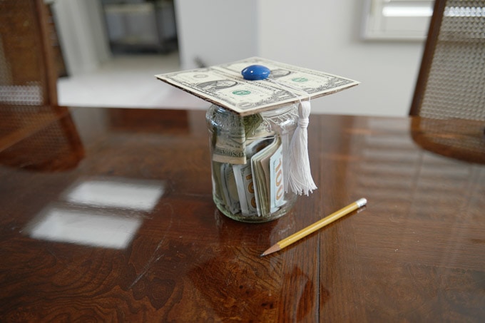 A super-easy college savings jar made with a cardboard grad hat lid. This would be a really great way to gift money to a teen