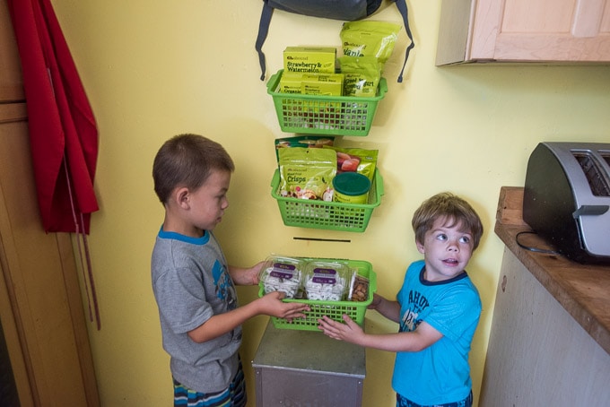 Creating a healthy snack station with hangable/removable wall baskets so parents can easily see how snack supply is doing for lunch prep, and kids can quickly grab something without ransacking the cabinets between meals.
