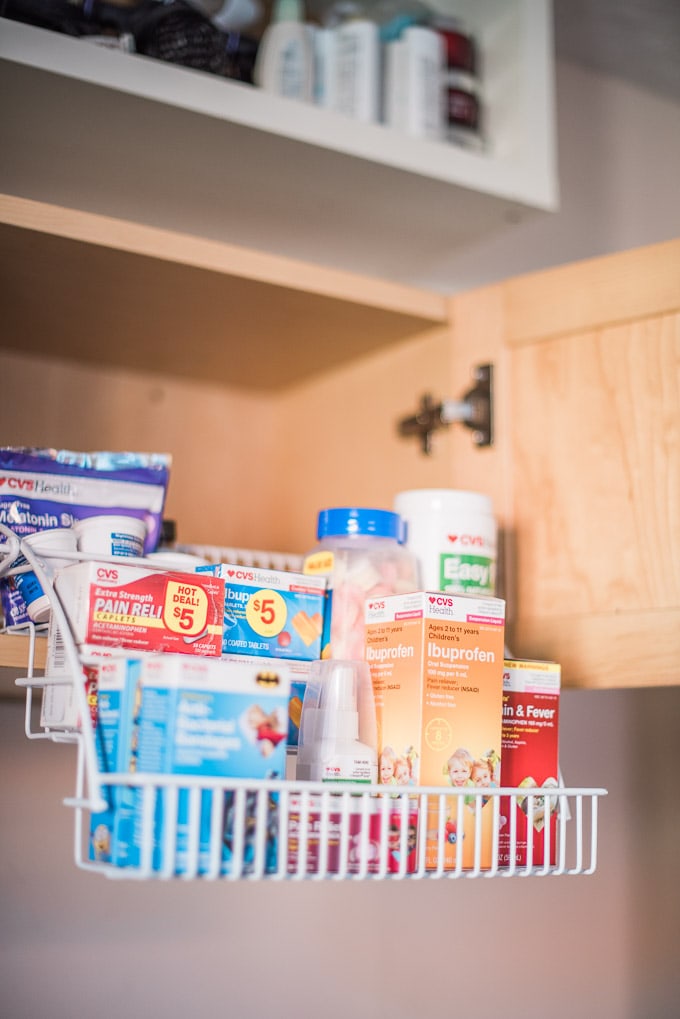 Super-simple medicine cabinet organization with a pull-down spice rack.