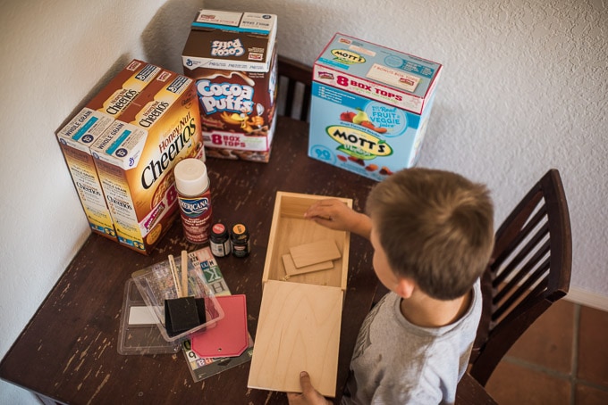 Crafting a Box tops box for collection in the classroom using an old wooden puzzle box.