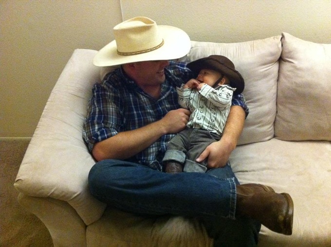 Dad and baby dressed up as cowboys for their first Halloween.