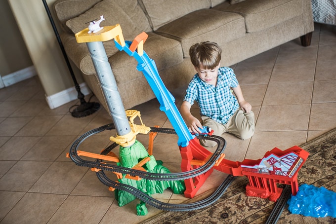 Preschooler playing with Trackmaster set