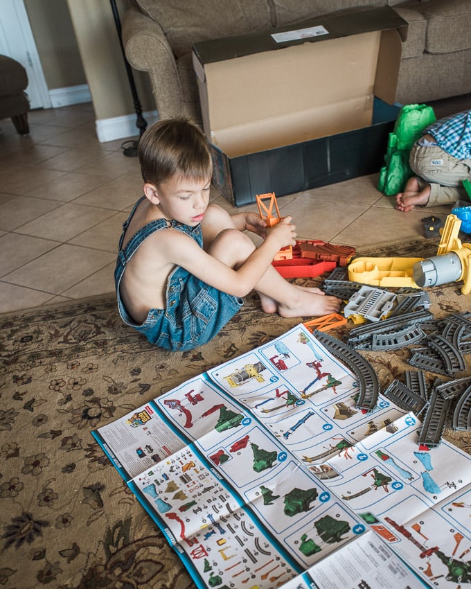 5-year-old putting together Thomas & Friend Sky-High Bridge Jump toy