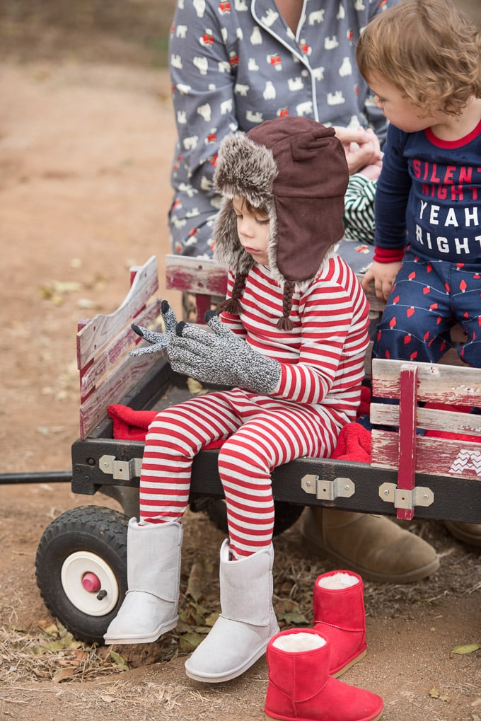 4-year-old in pajamas and critter hat with gloves