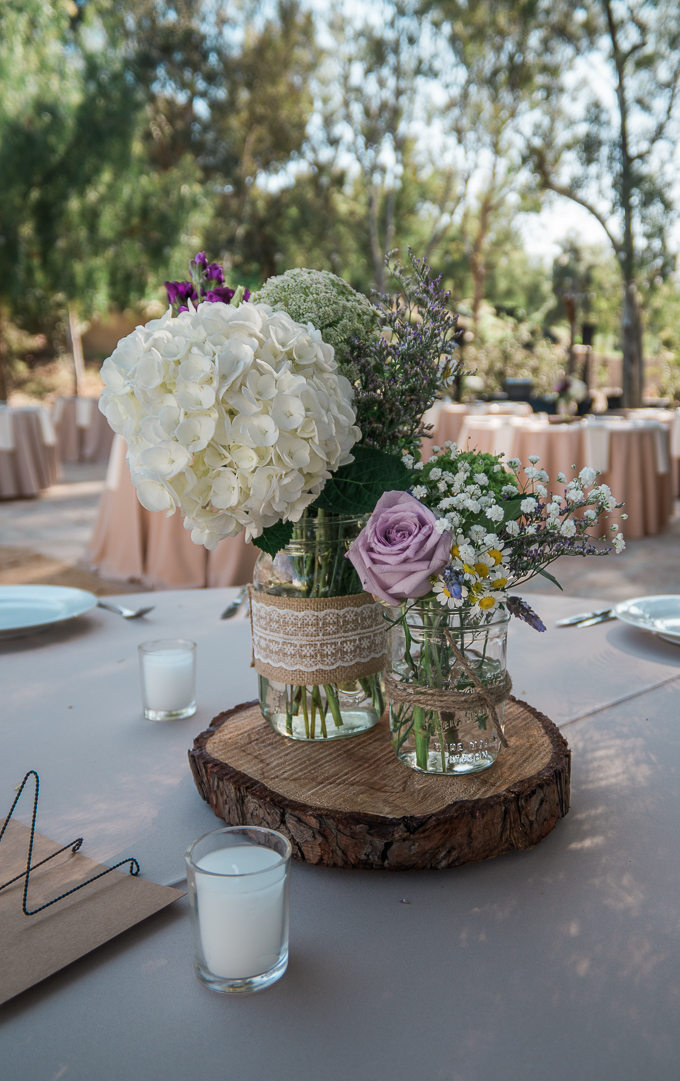 Casual mason jar flowers at an outdoor wedding