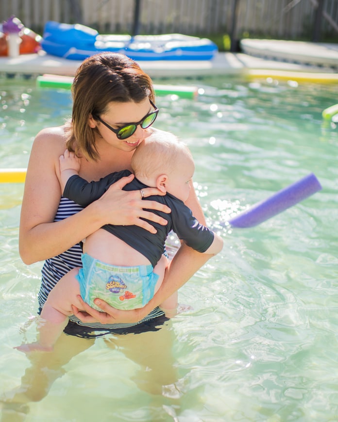 Mom holding baby in the pool