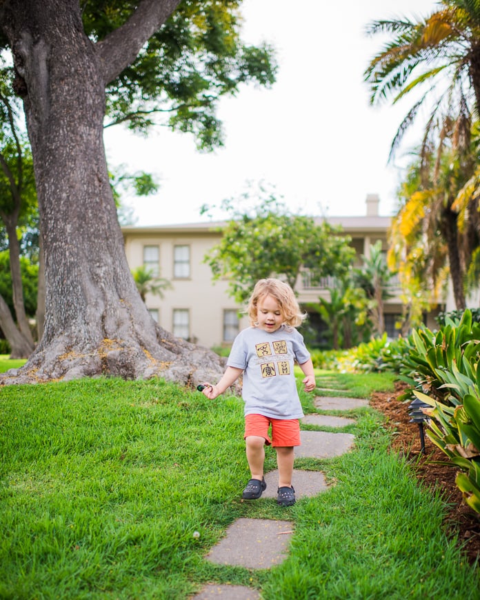 Toddler playing around on the grass in Goleta CA