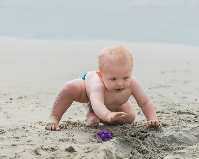 Baby eating sand
