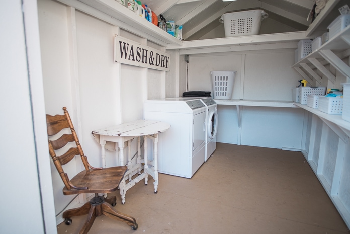 Outdoor laundry shed with shelves