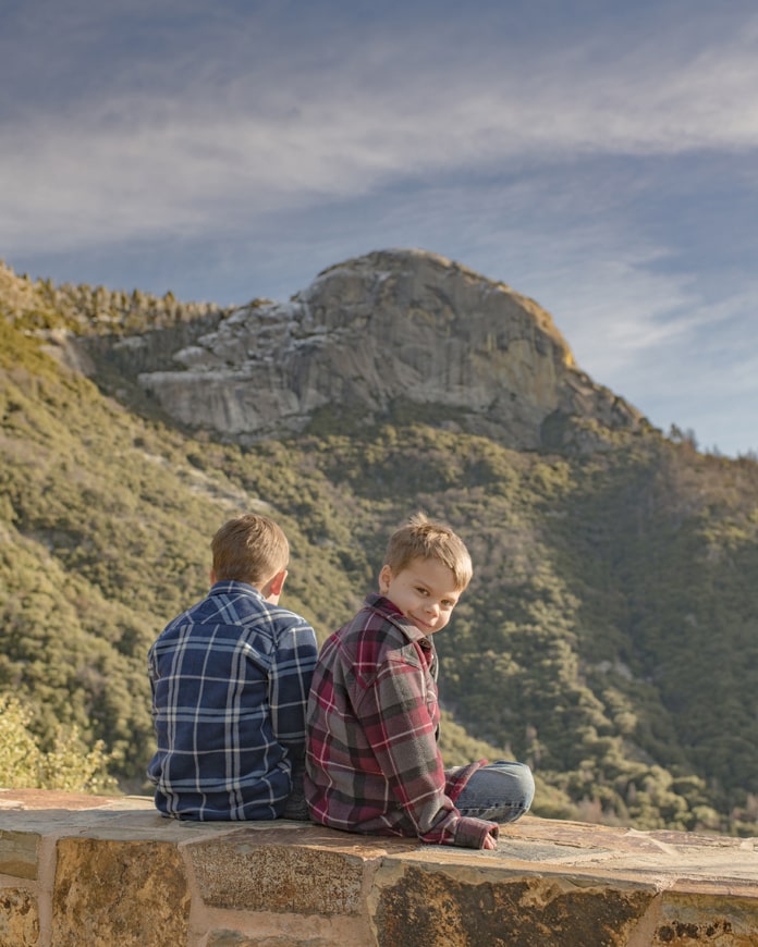 11 Children sitting on ledge looking at mountain