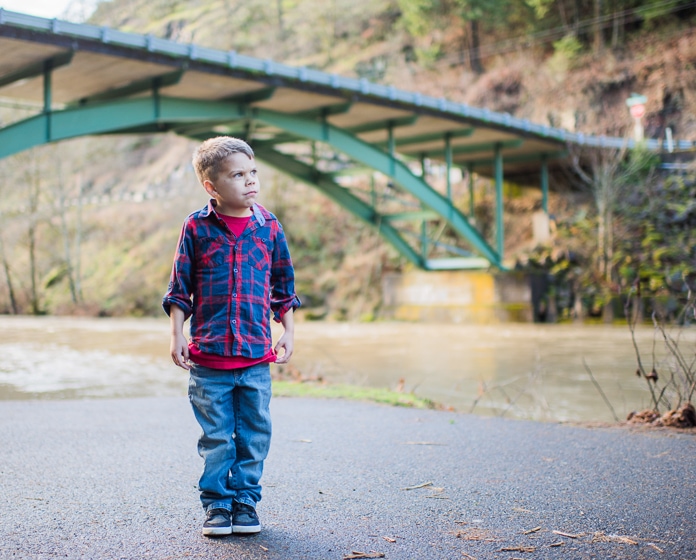 5-year-old standing under a bridge