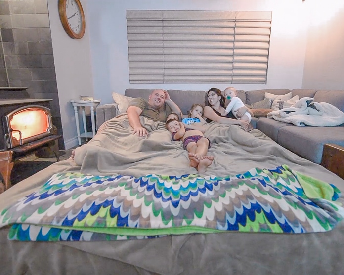 Whole family in a bed in the living room