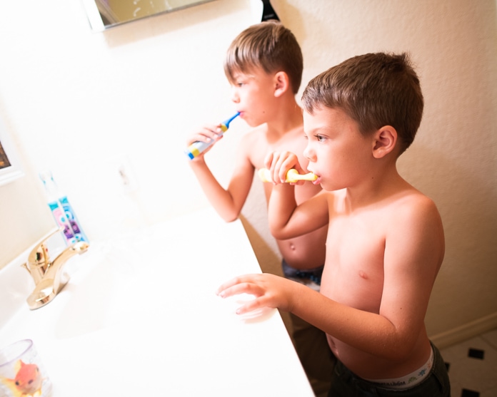 Boys brushing teeth together