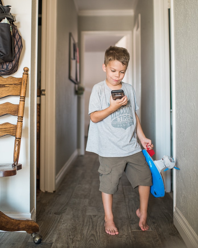 Kid holding phone with smart home controls
