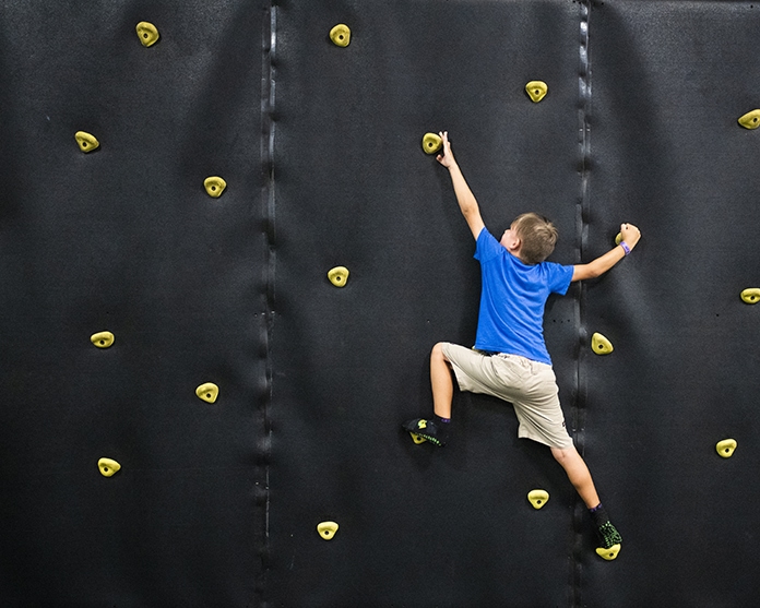 child on rock climbing wall