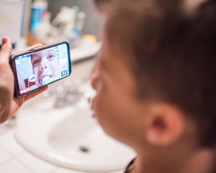 Boy brushing teeth with app