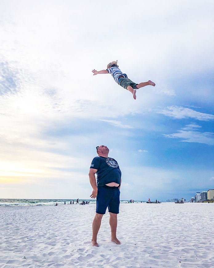 Father throwing child into air