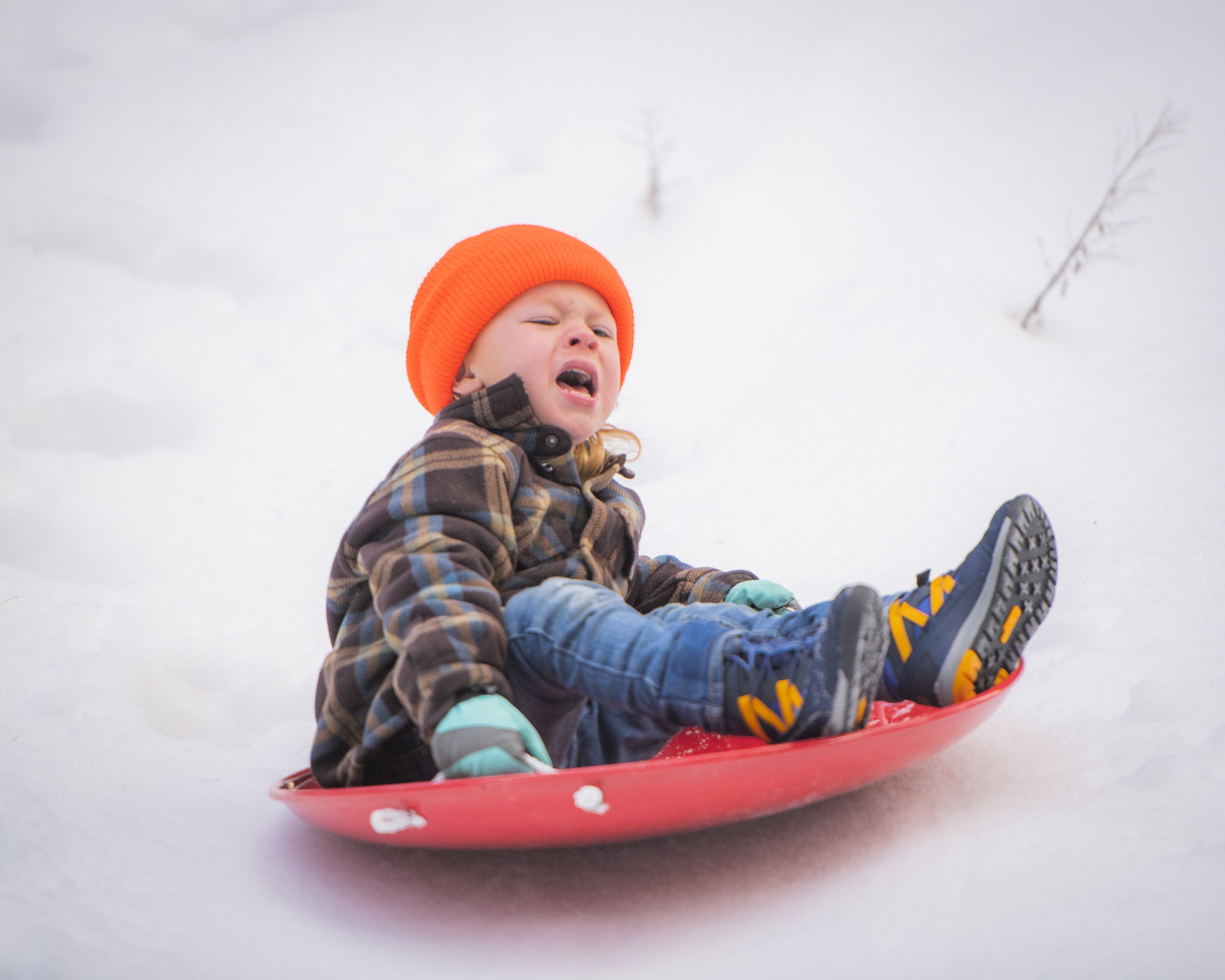 Crying baby on snow sled