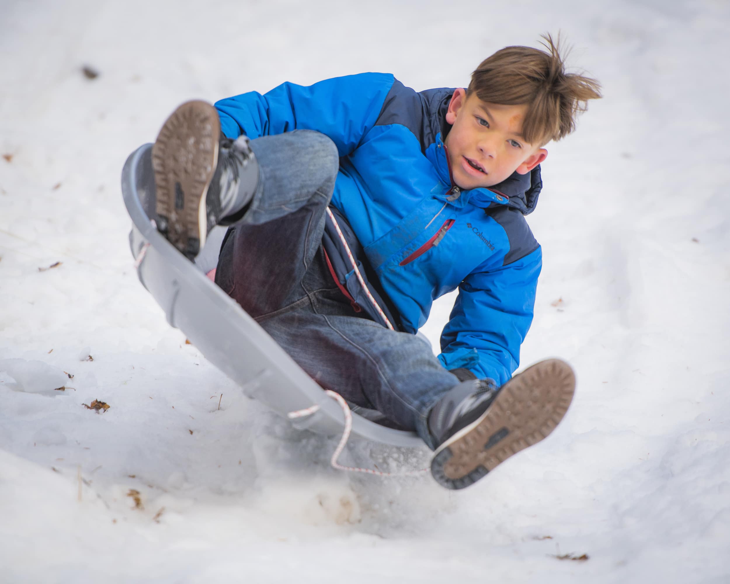 Kid crashing on snow sled