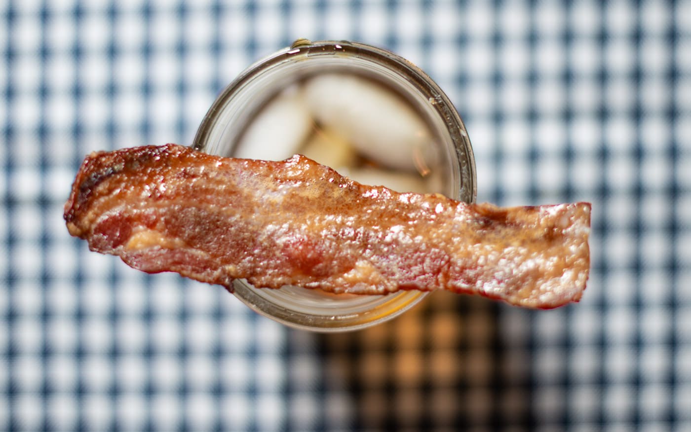 Candied bacon on a drink glass