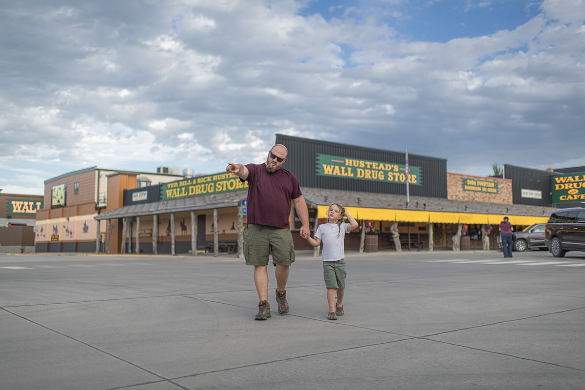 Father and son visiting wall drug in south dakota on Dad Travel trip
