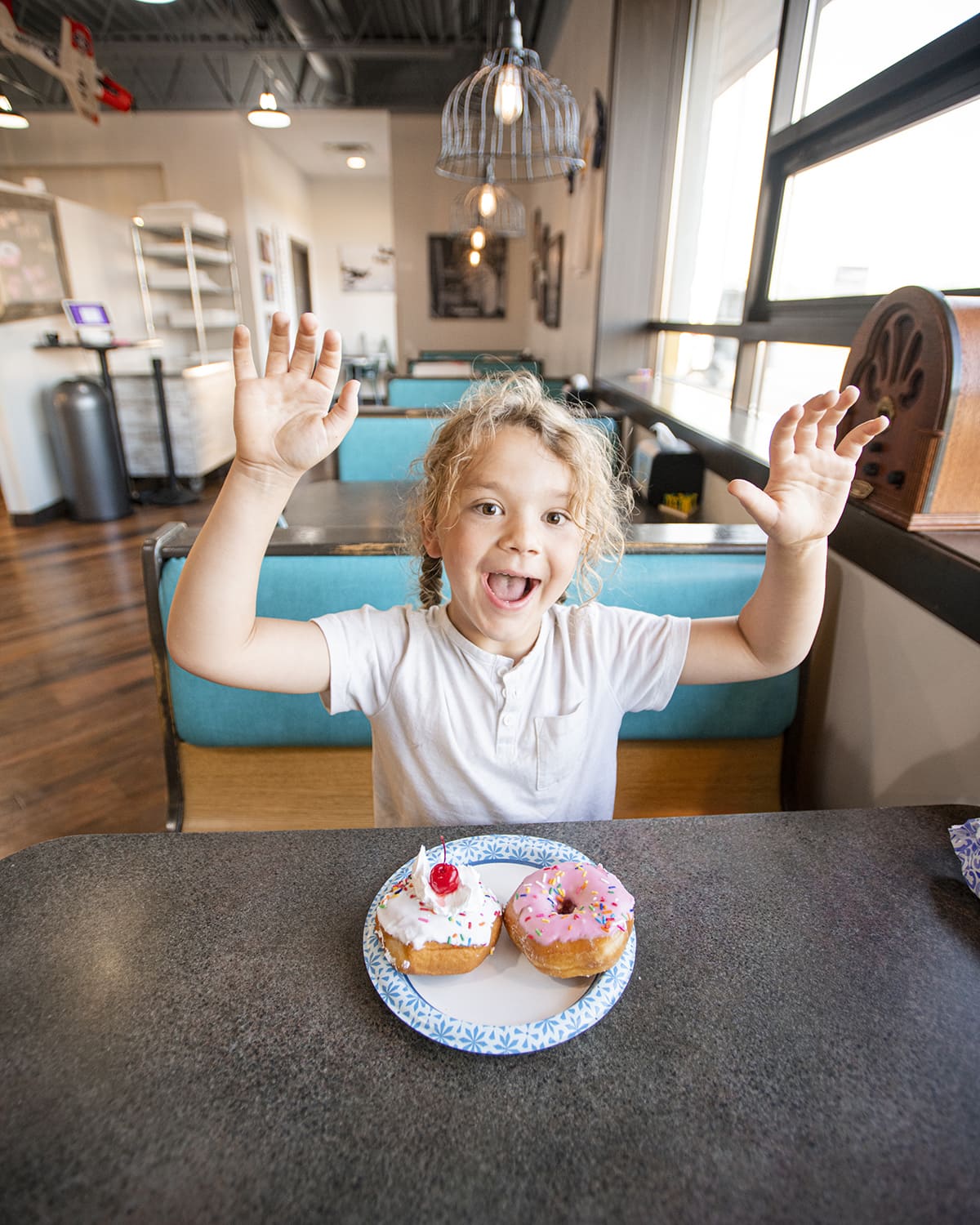 Happy boy with donuts from flyboy donuts in sioux falls south dakota