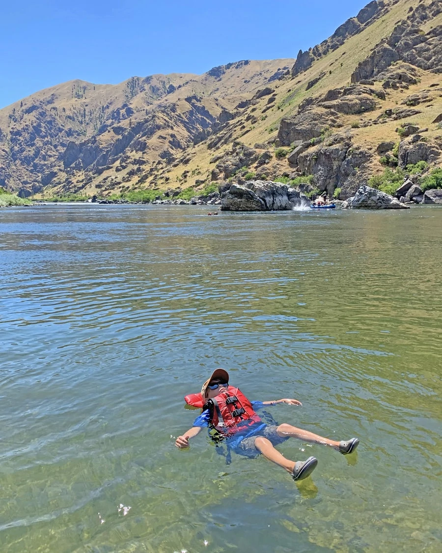 Relaxing little boy in hell s canyon on the snake river
