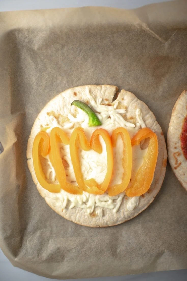 Cute pumpkin pizza made with bell peppers
