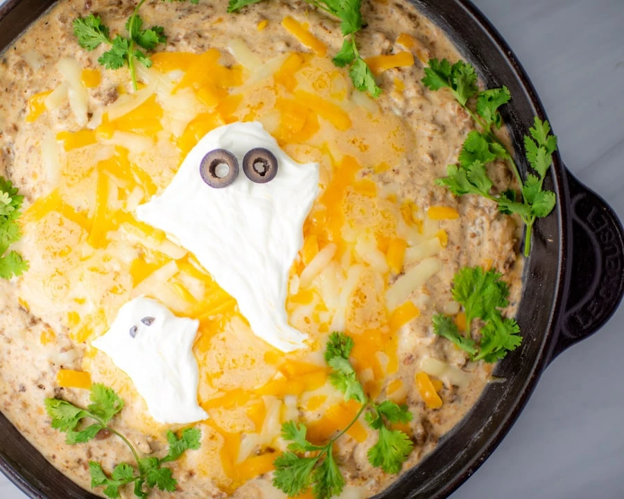 Halloween dip with beef, beans, cheese and sour cream
