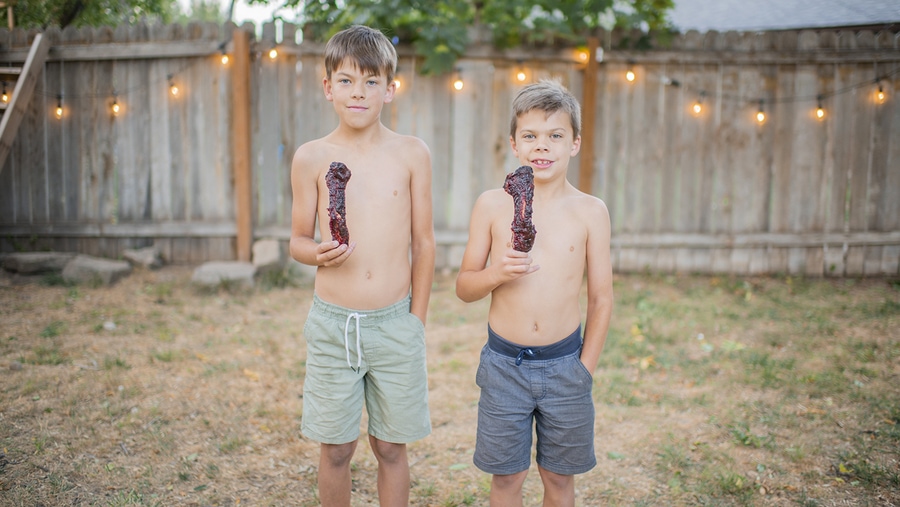 Two young boys enjoy the best smoked beef ribs from traeger pro 780 smoker