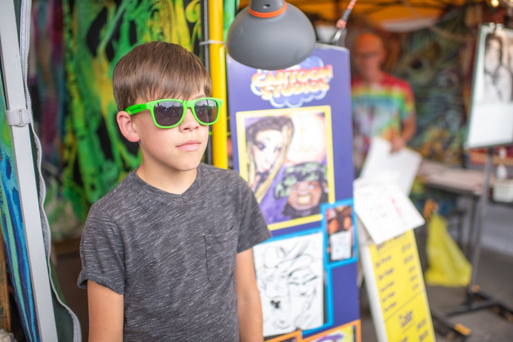Tween standing by caricature sign