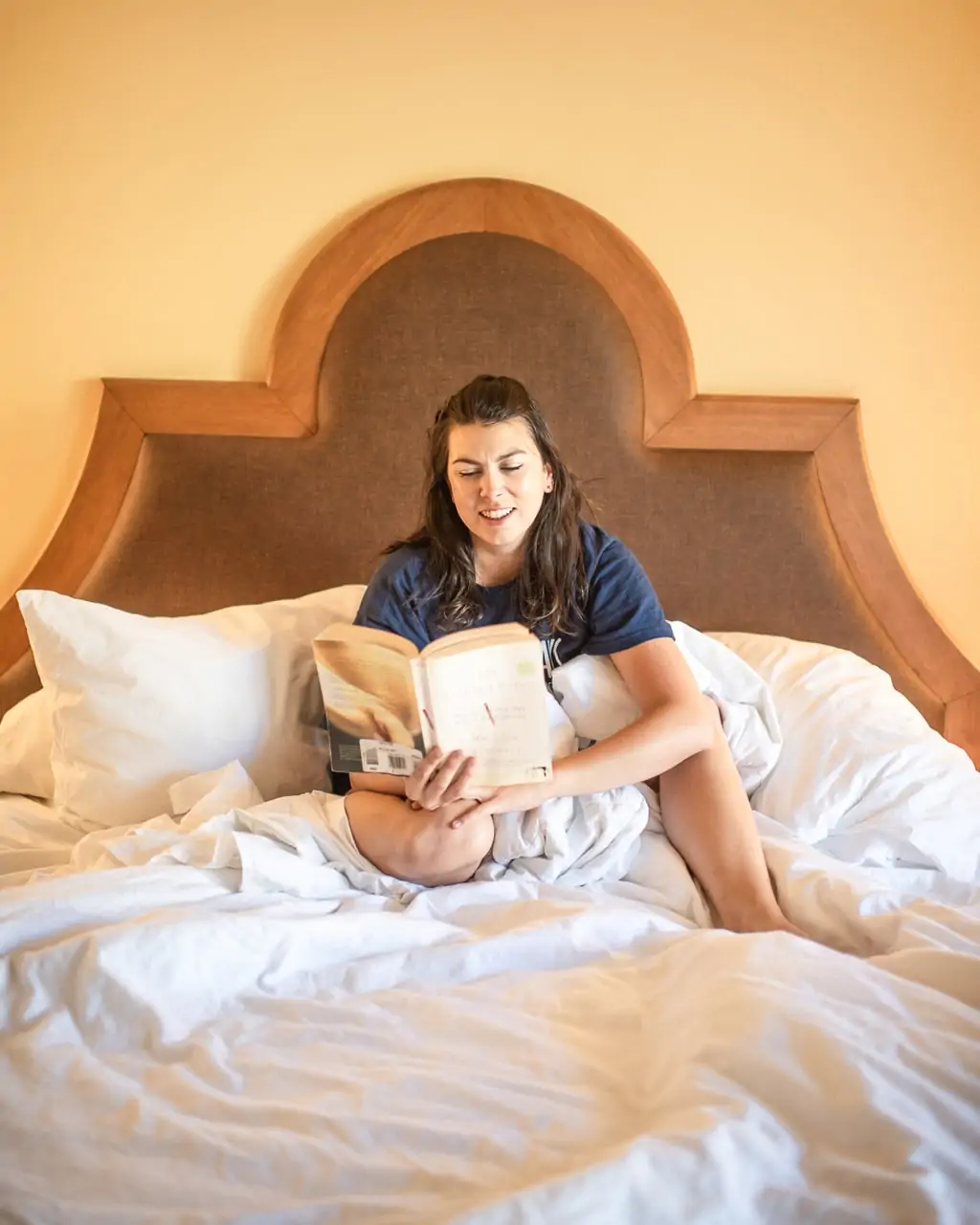 Mom reading book in bed