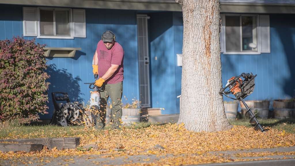 Using a STIHL KMA 130 R to clean up leaves for a little free library