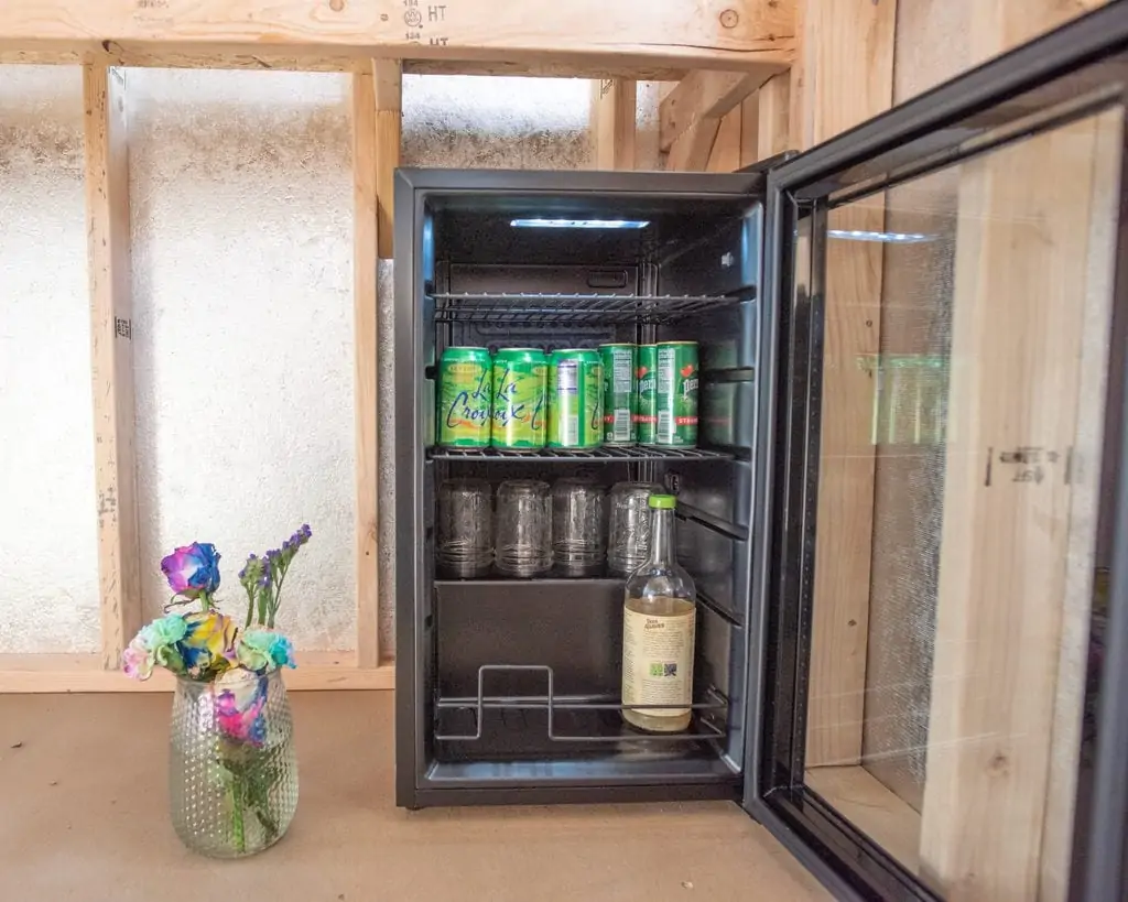 mini refrigerator with drinks and glasses