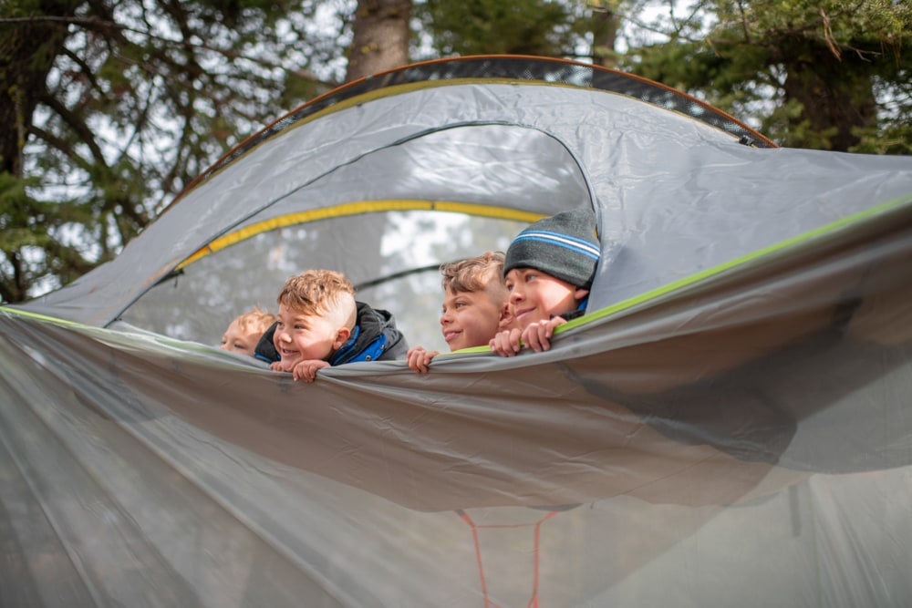 Happy kids in hanging tree tent