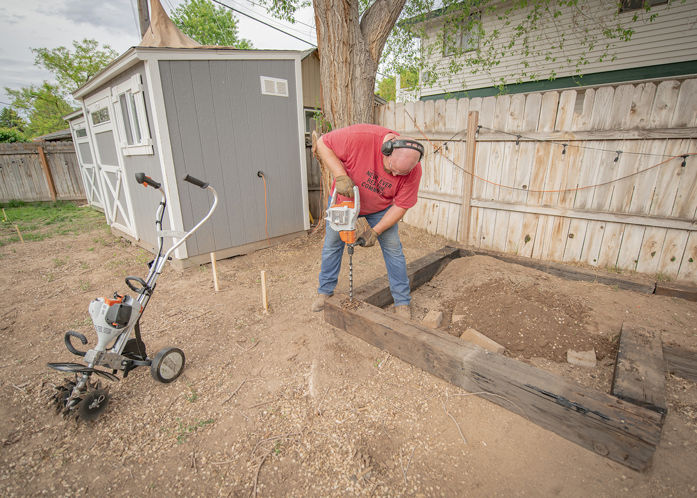 Nate day using bt 45 to anchor down railroad ties in barckyard remodel for backyard smokers