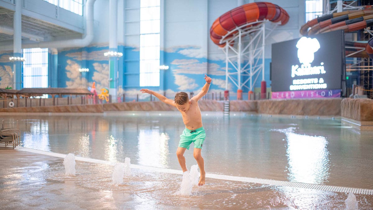 Kid jumping in fountain at kalahari waterpark resort