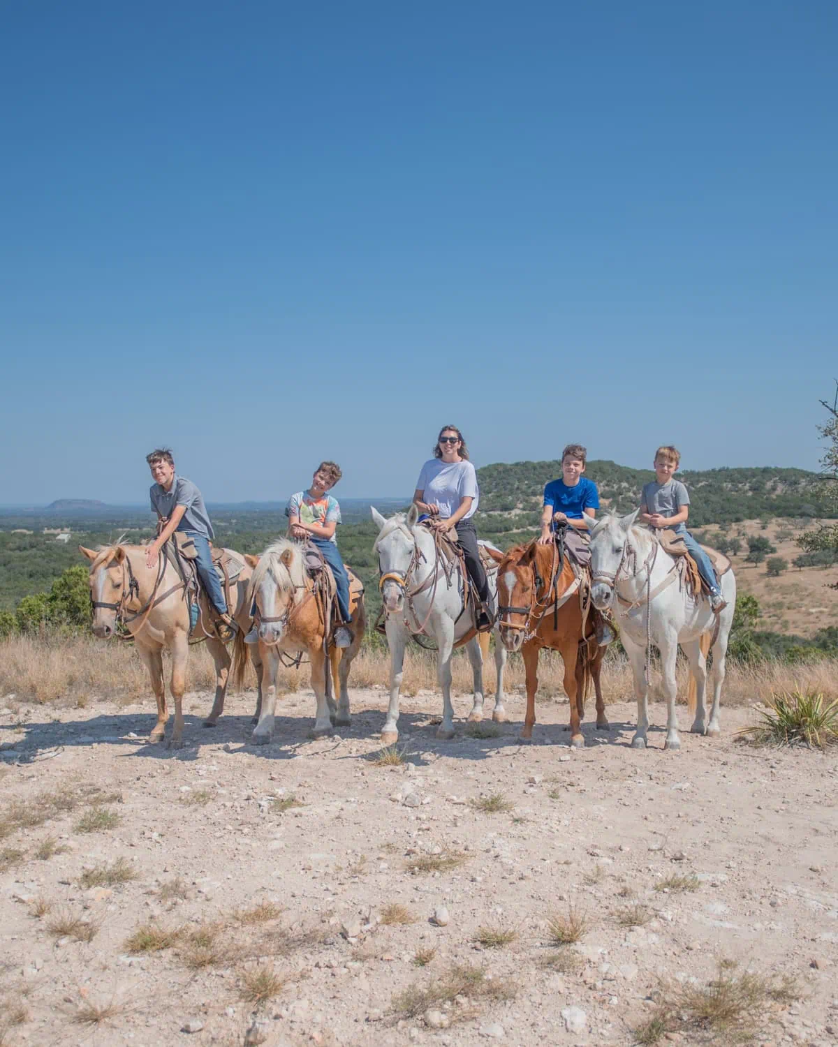 Mom and sons horseback riding in texas