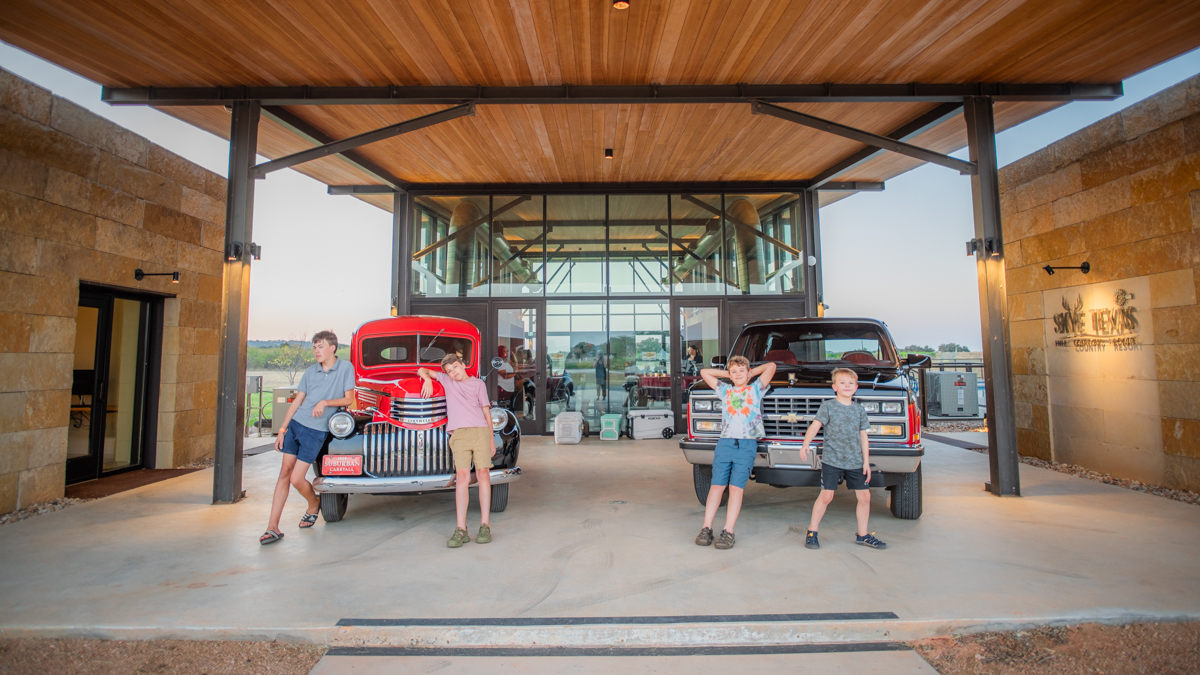 Boys in Texas in front of vehicles